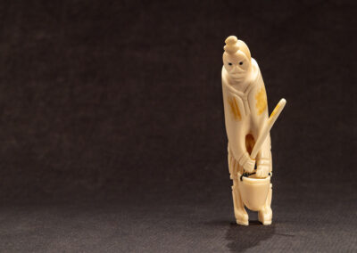 “Inuk Mother Carrying Pail”